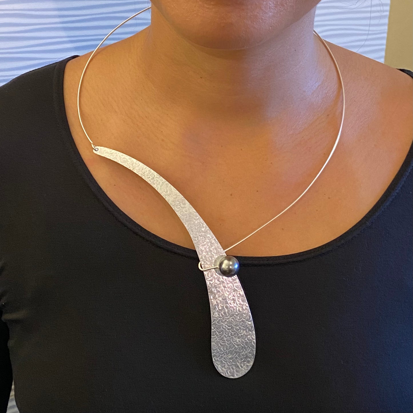 EBB Simple, off-center single wave necklace with simulated pearl and front clasp from the WATER Collection