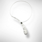 EBB  Simple, off-center single wave necklace with simulated pearl and front clasp from the WATER Collection