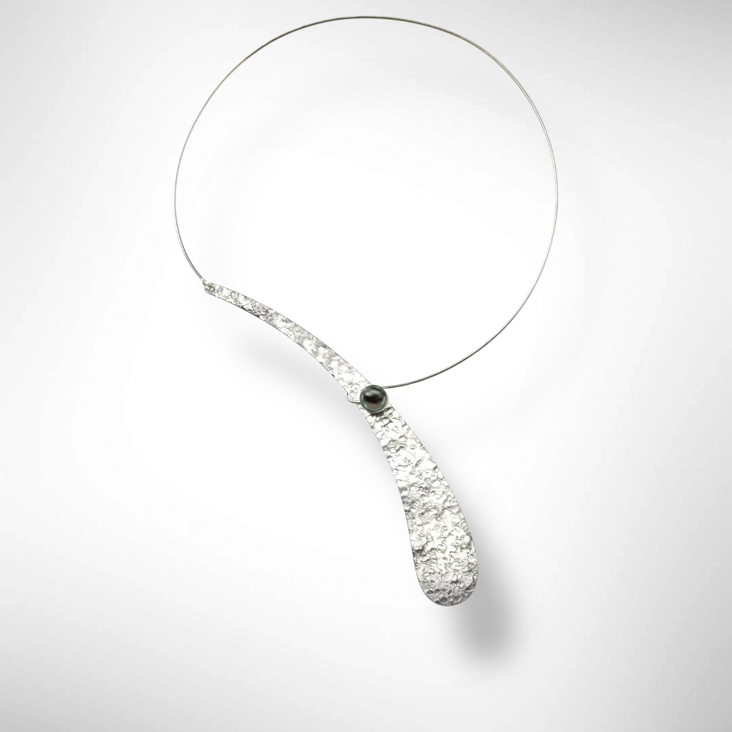 EBB  Simple, off-center single wave necklace with simulated pearl and front clasp from the WATER Collection