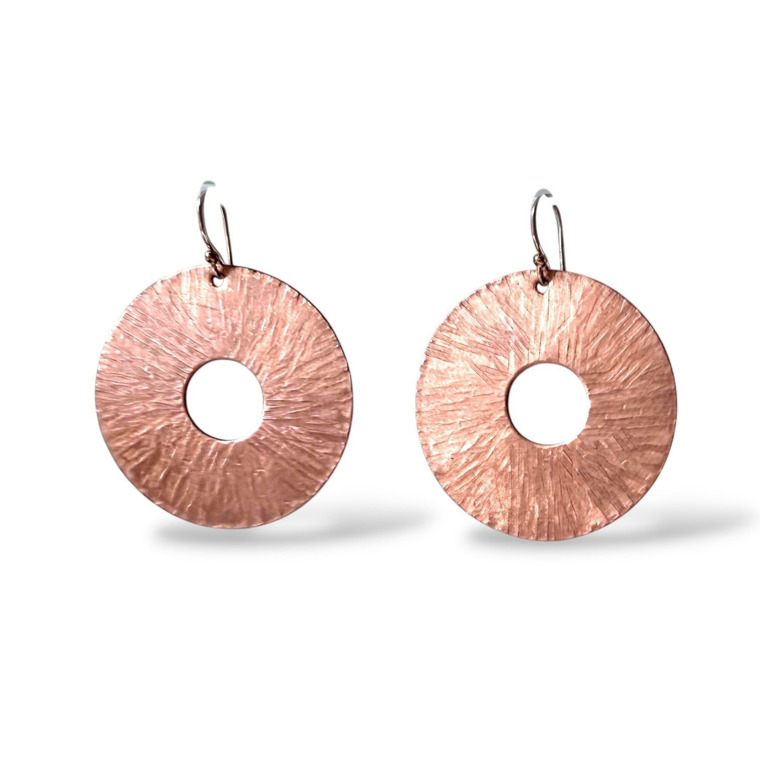 Chick Boss copper disc earrings with a textured, sunburst design and sterling silver ear wires.